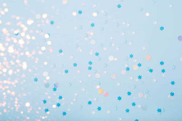 Little snowflakes confetti on blue background