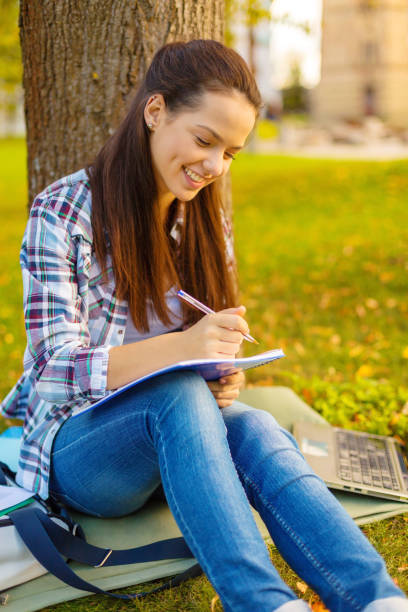 istock smiling teenager writing in notebook 1198010667
