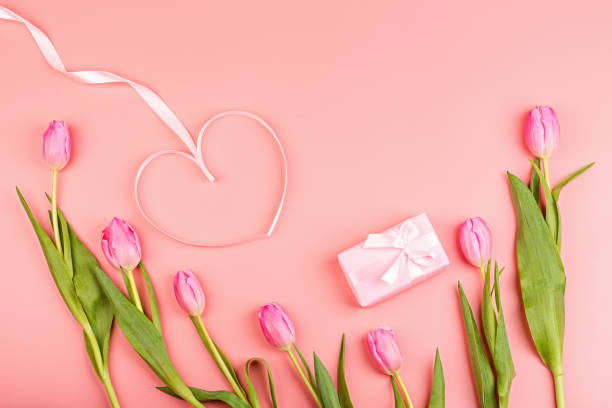 istock View from above tulips and gift box with copy space. Background for womens day, 8 March. Flat lay style, top view, mockup, template, overhead. Greeting for Womens or Mothers Day 1198013385