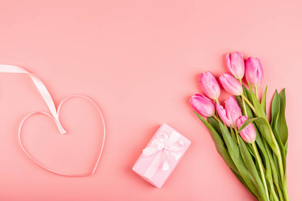 istock View from above tulips and gift box with copy space. Background for womens day, 8 March. Flat lay style, top view, mockup, template, overhead. Greeting for Womens or Mothers Day 1198013481