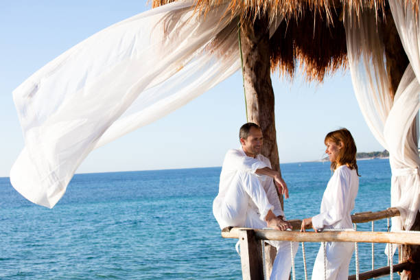 istock couple in a bungalow on the sea 1198018188