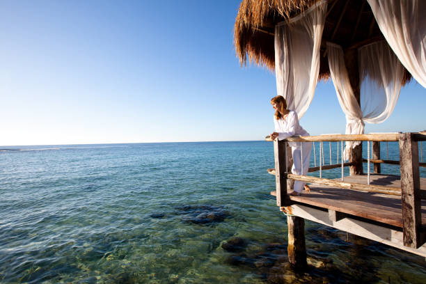 istock woman on a terrace on the sea 1198018904