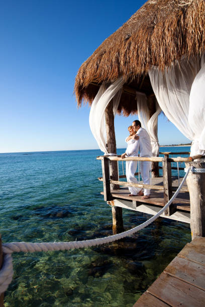 istock couple in a bungalow on the sea 1198018952