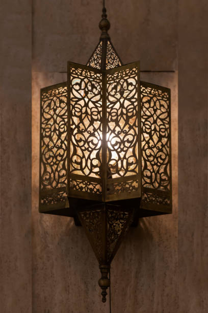 istock Lit, Moroccan, Arabian lamp with intricate decor hanging on wall. 1198024171