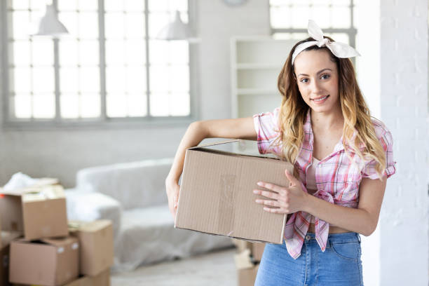 istock Woman unpacking in new home 1198028235