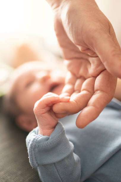 istock Baby Holding Mothers Hand 1198028391