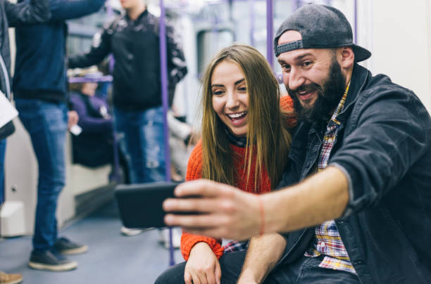 istock Couple taking selfie in the subway train 1198029231