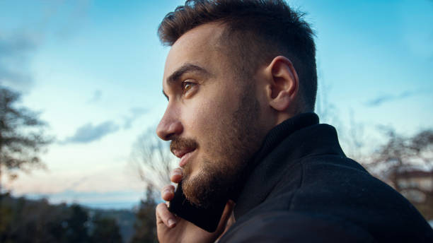 istock Young handsome brunette turkish man talking on the phone at sunset 1198029396