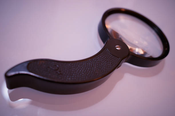 istock Pinky magnifying glass in detail background 1198029552