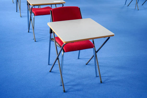 istock Exam desks in a exam hall 1198030765