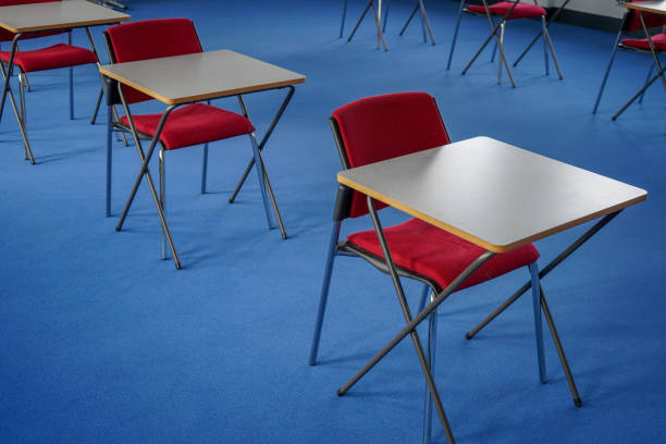 istock Exam desks in a exam hall 1198030863