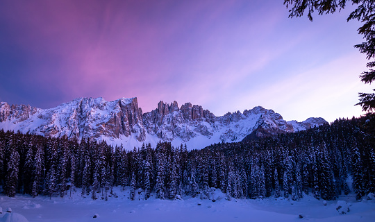 panoramic view of snow covered karersee (lago di carezza) and latemar in winter; unesco world heritage, dolomites, italy;