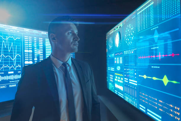 istock The businessman looking on the blue screen 1198034139