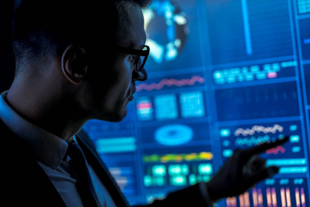 istock The man in suit works with data on a blue screen 1198034163