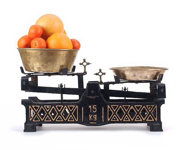 istock Old-fashioned balance scale with citrus 119803468