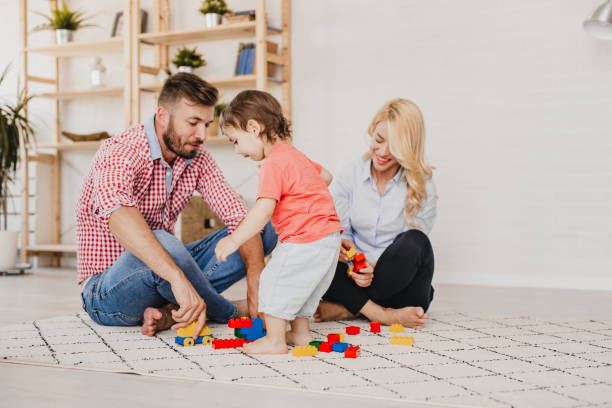 istock Young family playing with their son at home 1198035025