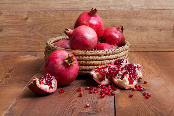 istock Pomegranate isolated on wooden background. 1198035302