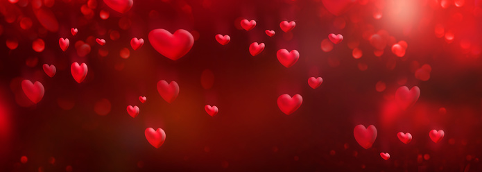Flying red hearts with romantic bokeh effects. Abstract background for valentines day and wedding with space for design and text.