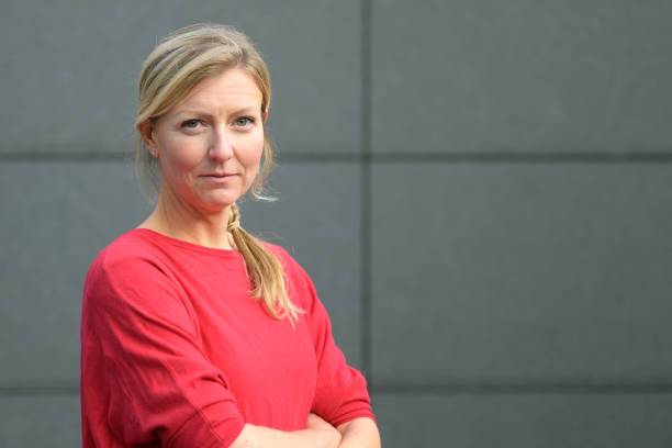 istock Attractive blond woman smiling at the camera 1198037456