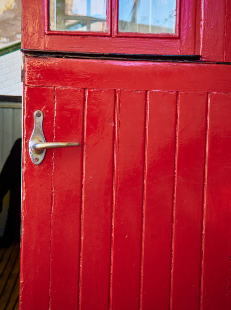 istock Red wooden door with a metallic door handle. 1198038561