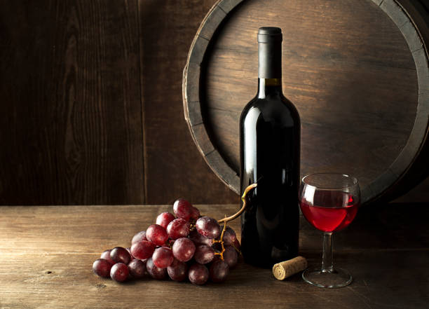 istock Bottle of red wine with barrel 1198038728