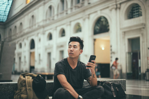 istock Young tourist is text messaging on a train station 1198038877