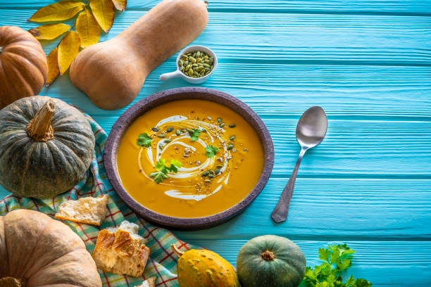 istock Autumn pumpkin soup and ingredients on turquoise 1198039019