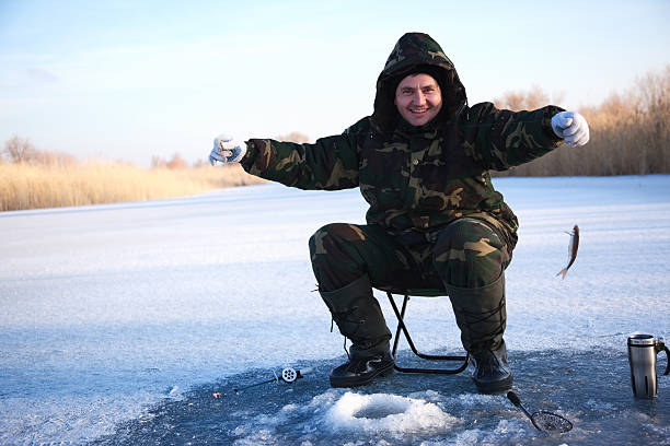 istock Fisherman on winter lake 119804151