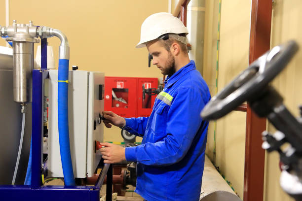 istock Engineer of substation starts technological process. Management technological equipment 1198041802