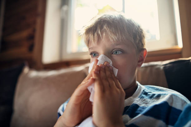 портрет больного мальчика, чистящего нос - house dust allergy стоковые фото и изображения
