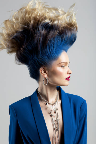 Beautiful young woman with hair of turquoise color looking at camera, top view. Image of seamaid.