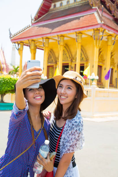 istock Two asian friends taking selfie 1198045366