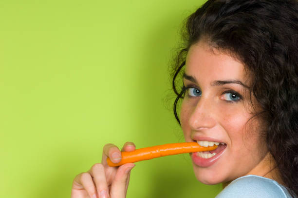 istock young woman with carrot 1198047441