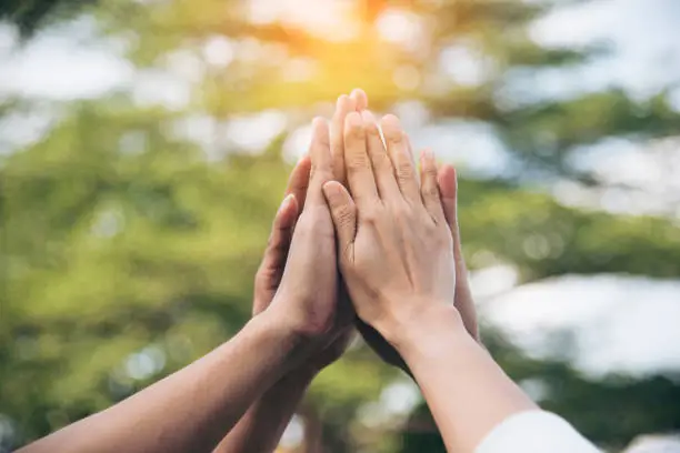 Teamwork high five as team together hands air greeting  power tag team. Group of diversity people multiethnic