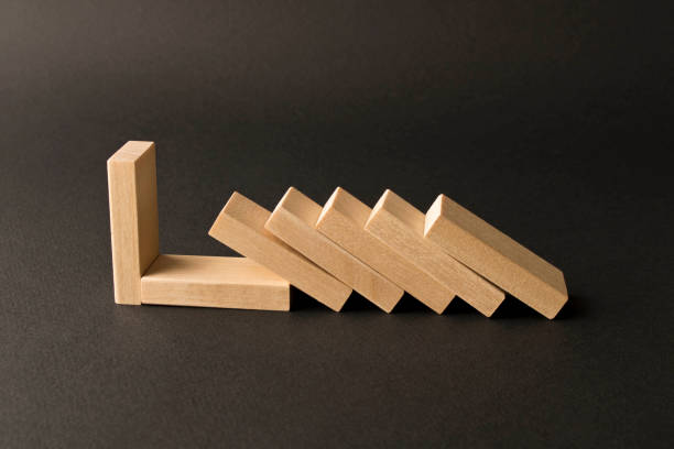 istock Playing dominoes on a dark background. Leisure games concept. Domino effect. Selective focus. 1198050480