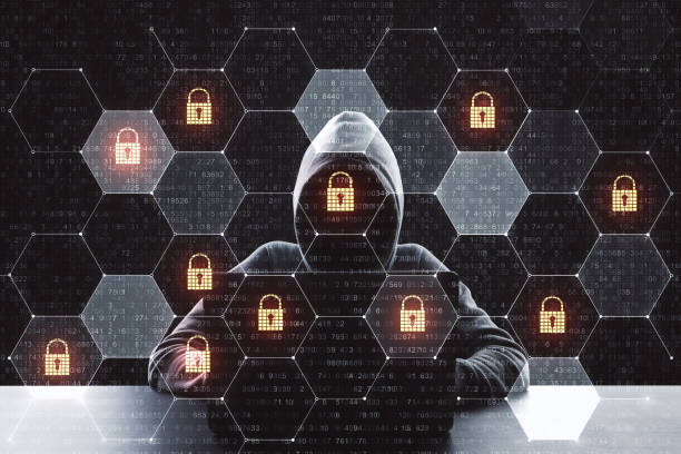 istock Digital crime concept with hacker using laptop and lock icons in cells.Double exposure. 1198051131