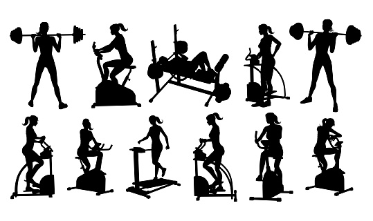 A woman in silhouette using pieces of gym fitness equipment and machines set