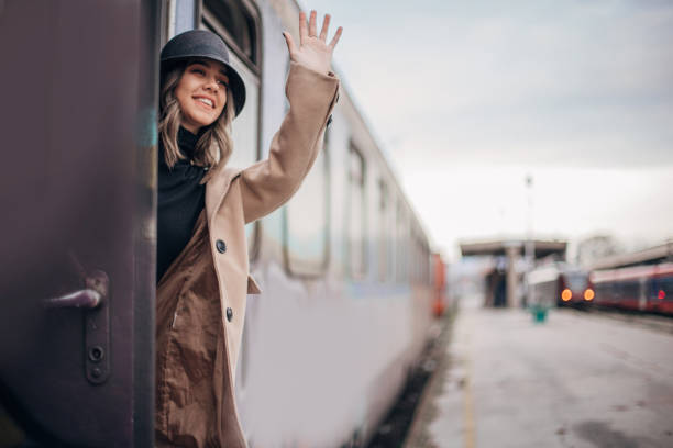 istock Elegant young woman is going on a train trip 1198056697