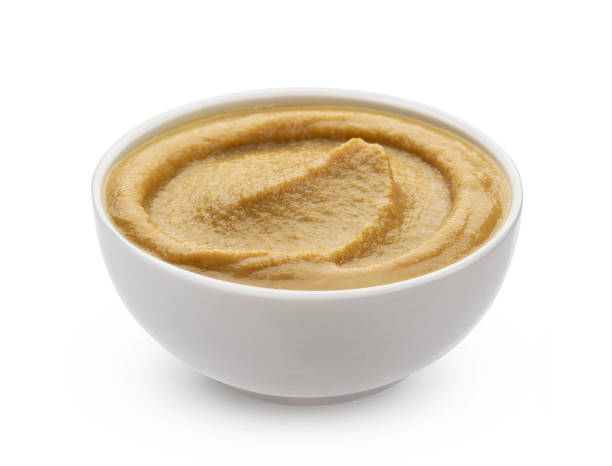 istock Mustard in bowl isolated on white background 1198058706