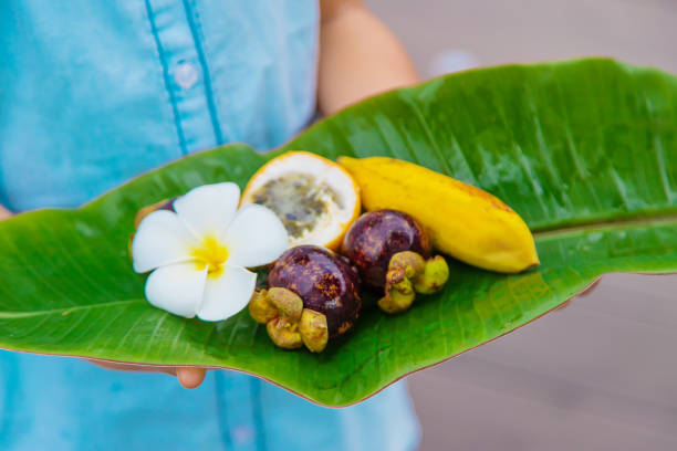 istock Child in hands with exotic fruits. Selective focus. 1198060165