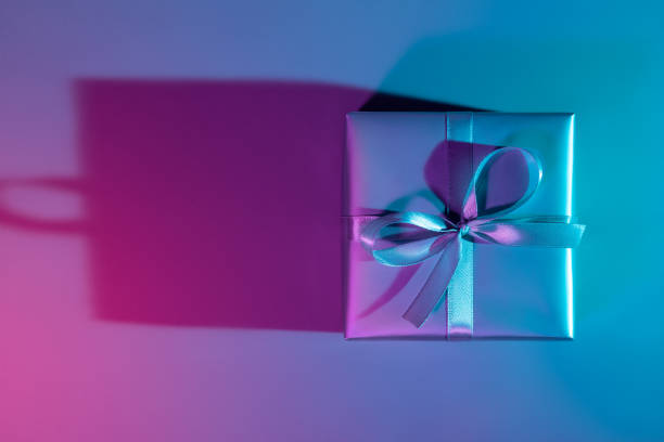 istock Gift box illuminated with colorful lights 1198065690