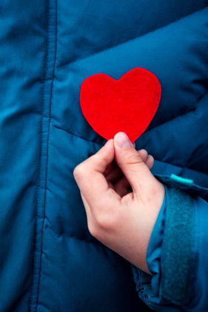 istock Heart for valentines day on warm winter jacket background 1198066076