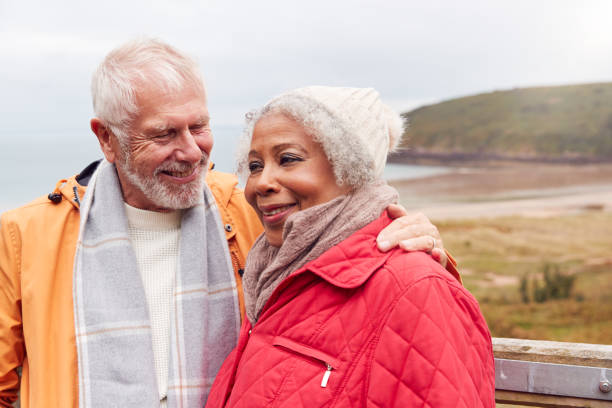 istock Loving Active Senior Couple Resting By Gate As They Walk Along Coastal Path In Winter 1198066109