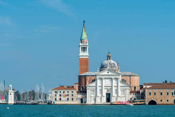 View of San Giorgio Maggiore, a Benedictine church on the island of the same name in Venice, Italy. View of San Giorgio Maggiore, a Benedictine church on the island of the same name in Venice, Italy. It was built by the Benedictines between 1566 and 1610 and designed by Andrea Palladio, The church is a basilica in the classical renaissance style. The island of San Giorgio Maggiore is right at front of the main island of Venice and it can be seen from the Riva degli Schiavoni through the Grand Canal. san giorgio maggiore stock pictures, royalty-free photos & images