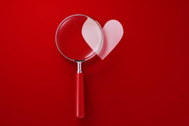 istock Magnifier and Heart Shape Over Red Background 1198071344