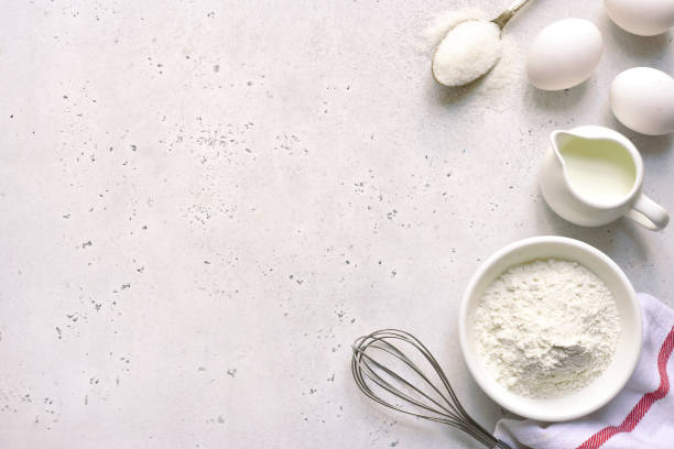 istock Culinary background with ingredients for baking : egg, flour, butter and milk 1198071700