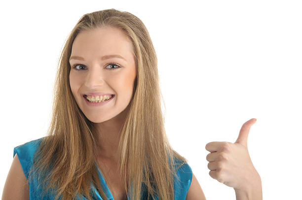istock Woman with brackets on teeth 119807391