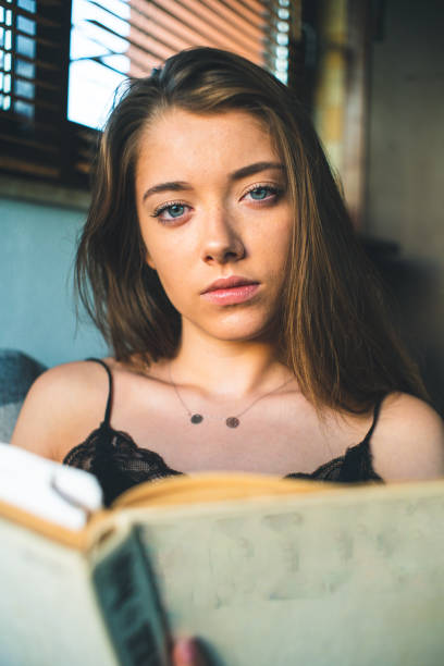 istock Girl reading book on the sofa 1198075561