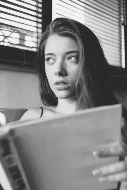 istock Girl reading book on the sofa 1198075763