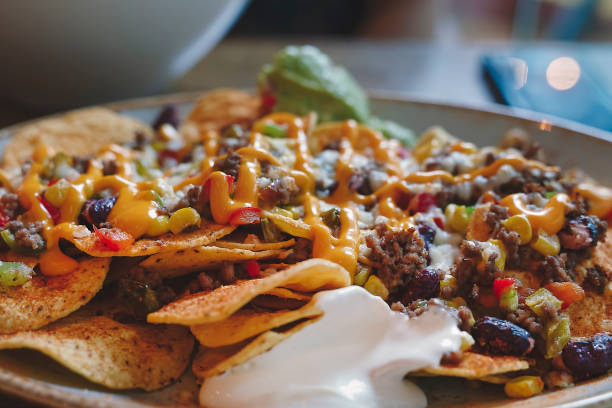 Mexican food, nacho with bean,cheese, beef and avocado
